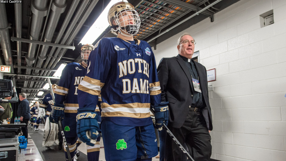 Father Conley walking with the hockey team prior to the 2017 Frozen Four showdown with Denver.