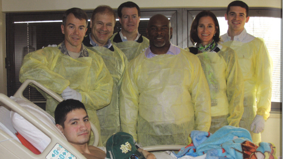Bryan Fenton (left) with members of the Monogram Club board of directors and staff at the Walter Reed National Military Medical Center in 2011.